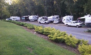 RVs and trucks parked along the campground road