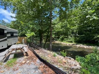 Picnic table beside the creek at a Laurel Creek RV Park campsite